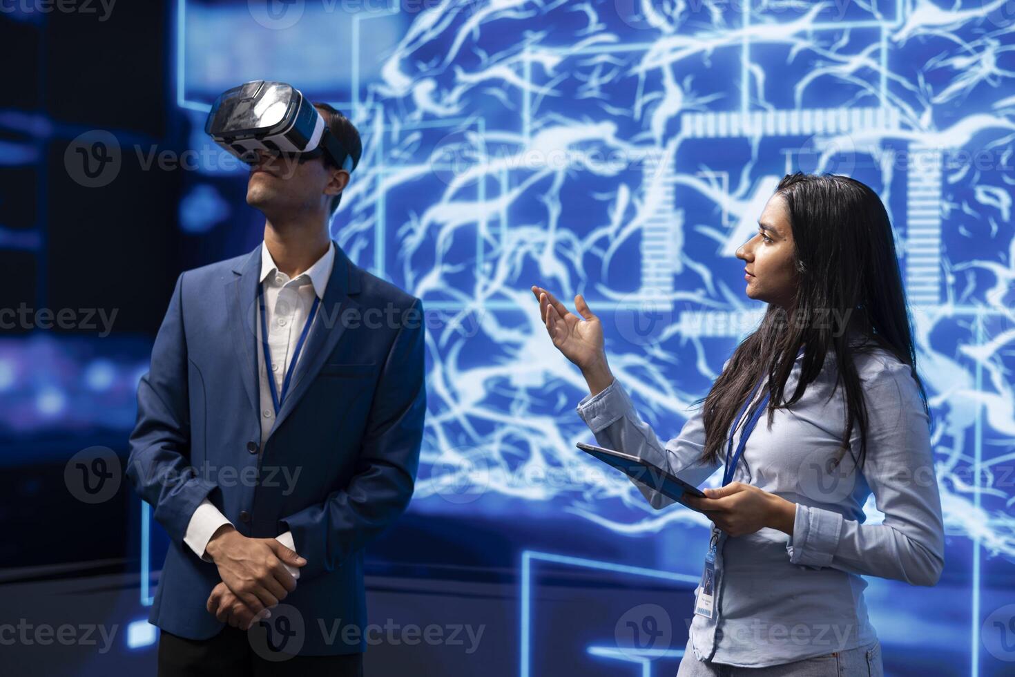 Technology company CEO using conference as platform to present latest AI and VR headsets products. IT experts at convention showing business investors virtual reality tech photo