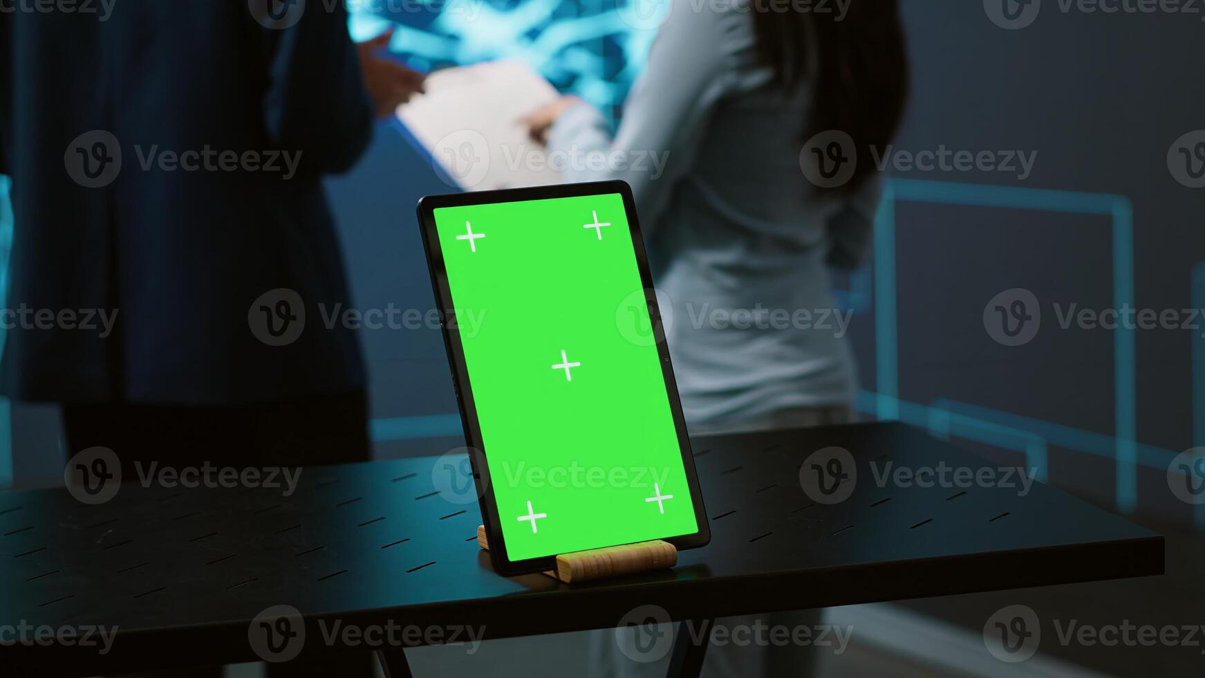 Green screen tablet used by computer scientists in startup doing advancements in AI field. Employees working on mockup device in workspace featuring artificial intelligence systems, camera A photo