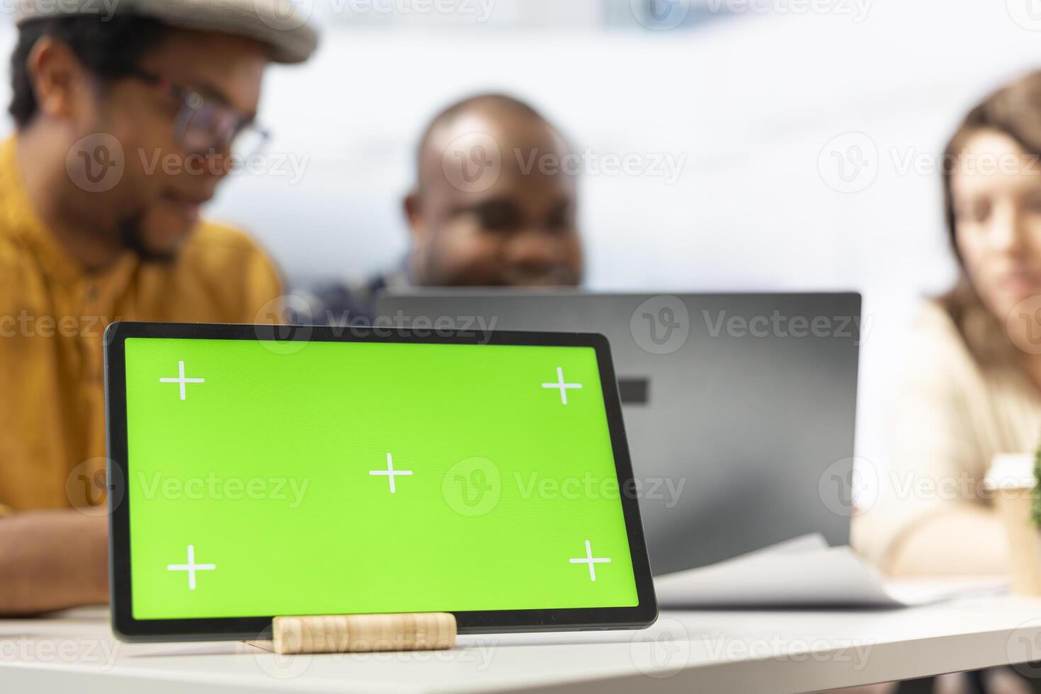 Real estate expert negotiating contract terms with clients next to mockup display, reviewing architectural blueprints for relocation in high class office space. Realtor shows investment possibility. photo