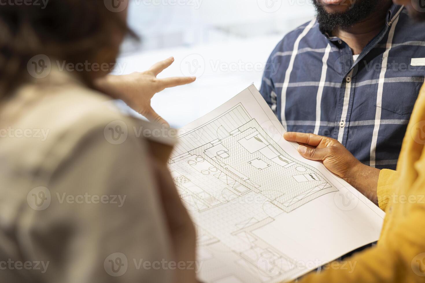 Business development team reviewing architectural plans for a high class office, considering a real estate investment strategy. Managers negotiating with the realtor during an office tour. Close up. photo