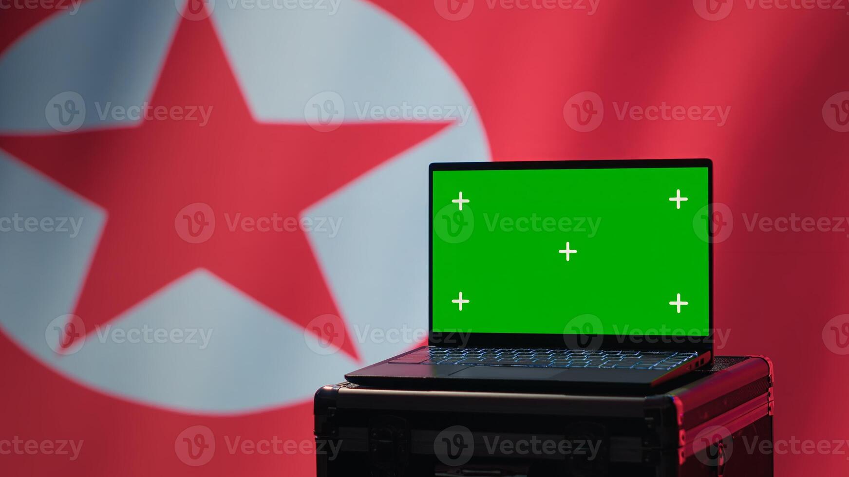 Isolated screen laptop in Pyongyang intelligence command center used by dictatorship party to run security protocols against NATO and South Korea enemies, isolated over North Korea flag, camera A photo