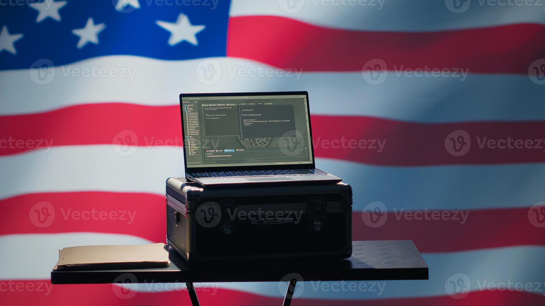 Laptop in CIA command center used by counterterrorism agents to run surveillance efforts against enemy of United States in conformity with Patriot Act law, isolated over USA flag, camera A photo