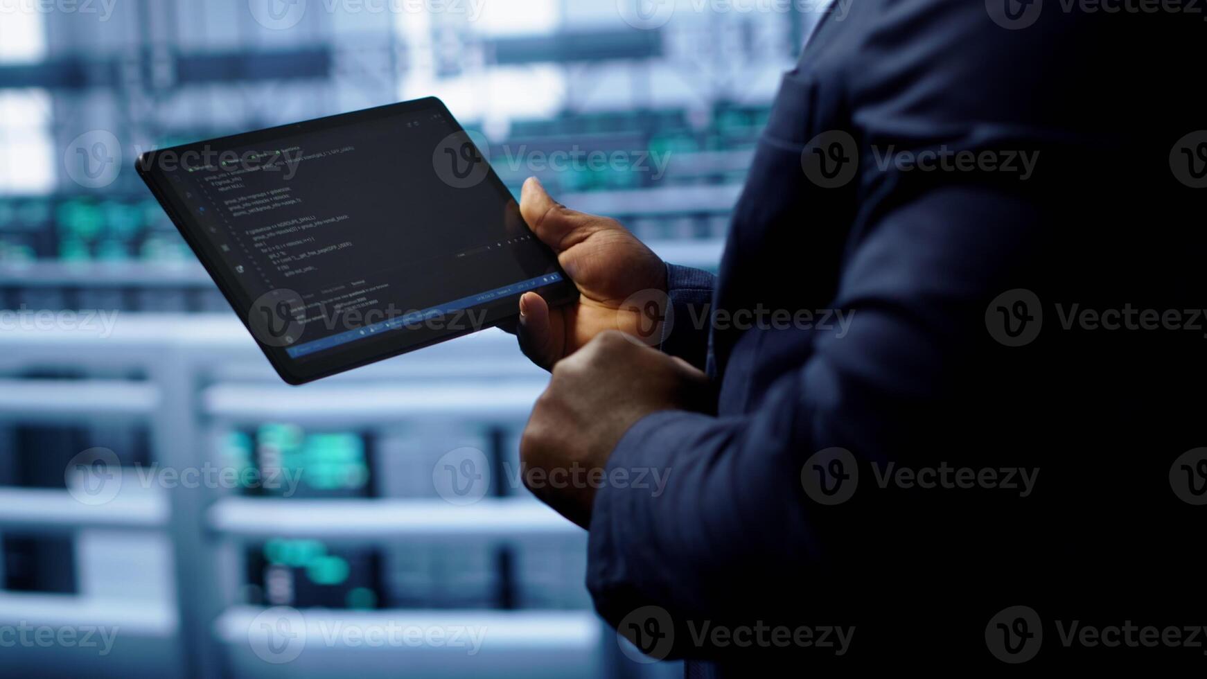 Engineer in high tech facility using tablet to patch network issues leading to slow data transfer rates. Close up of worker fixing errors affecting servers performance and connectivity, camera A photo