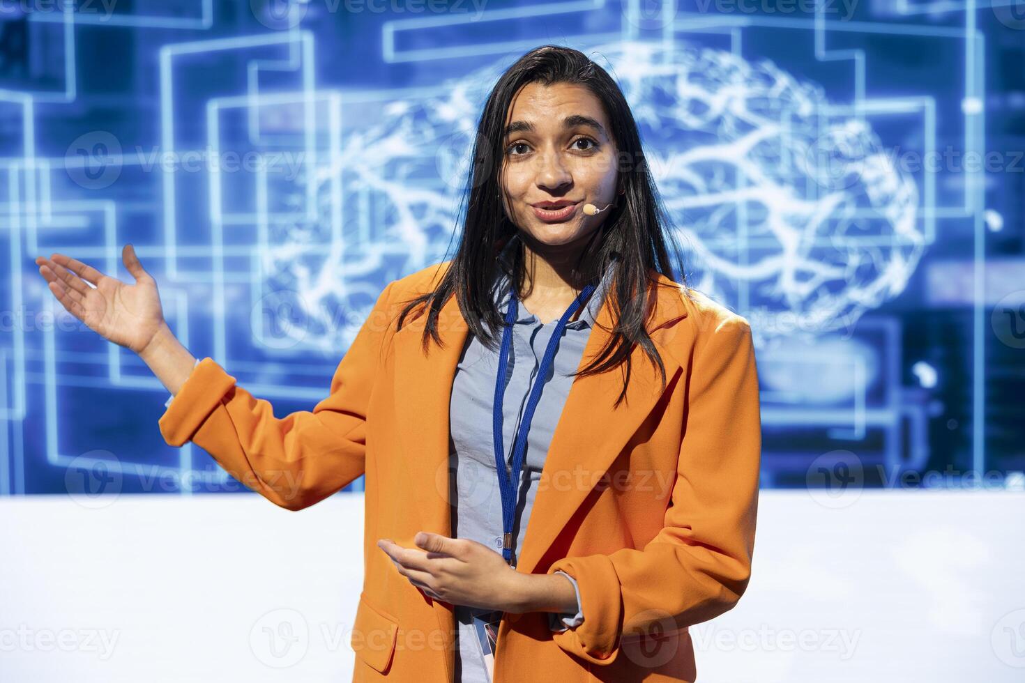 Portrait of engaging presenter talking at AI convention using mic, sharing industry expertise to inspire audience. Engineer exploring latest artificial intelligence products and tools at tech event photo