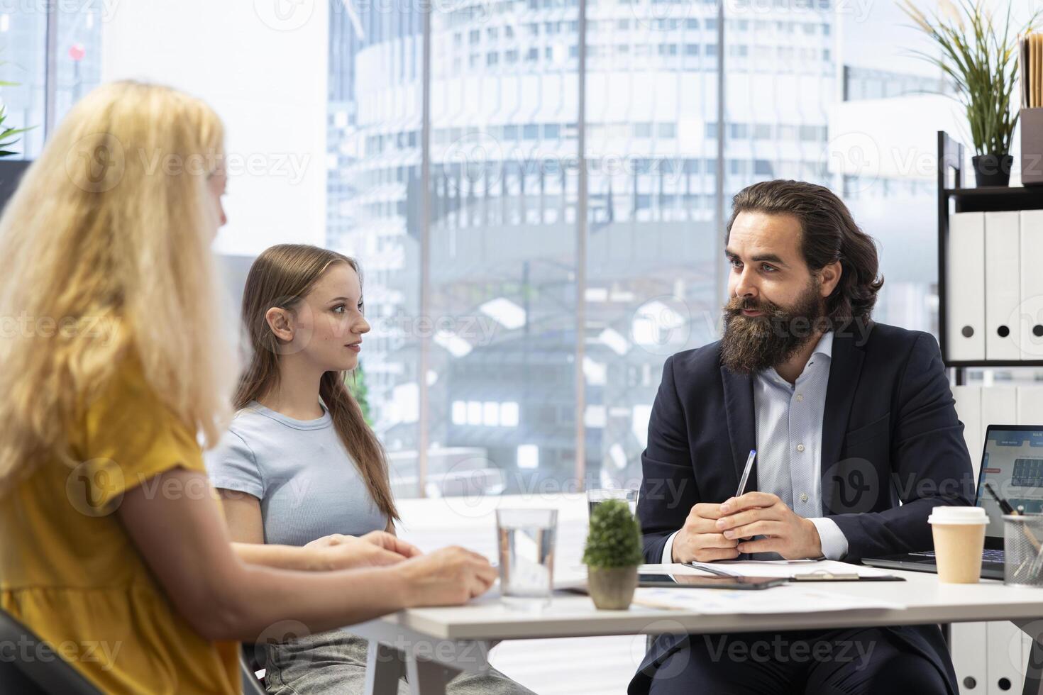 Financial advisor in workspace developing and presenting financial strategies and plans to customers. Consultant in office assisting clients with investment portfolio management photo