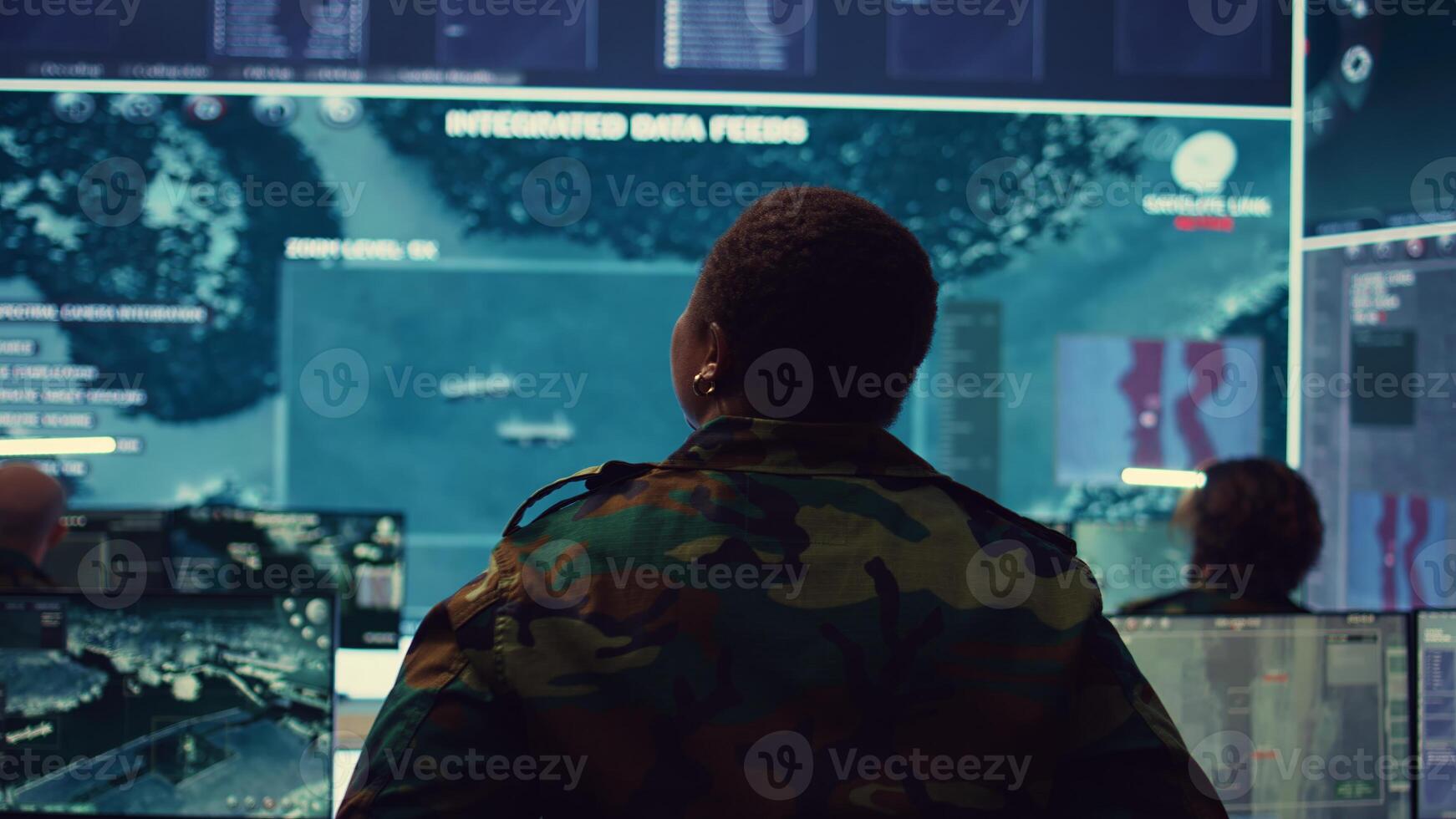 Female technical sergeant monitoring air traffic to detect any enemy aircraft, working in federal reconnaissance system to ensure national safety. Woman officer uses big screen and gear. Camera B. photo