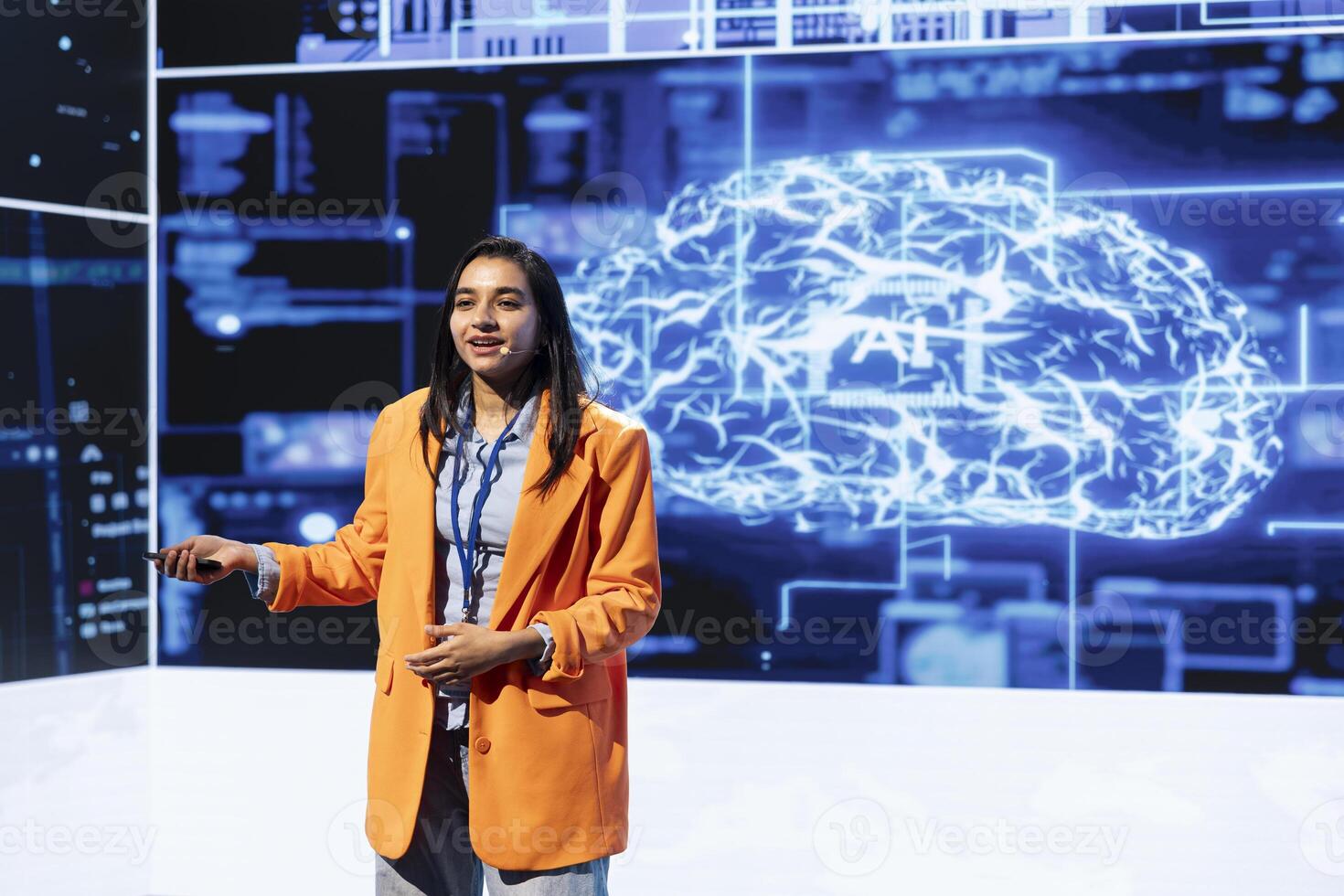 Smiling IT specialist holding presentation exploring ways emerging AI technologies can enhance companies workforce. Indian woman at event presents strategies for using artificial intelligence photo