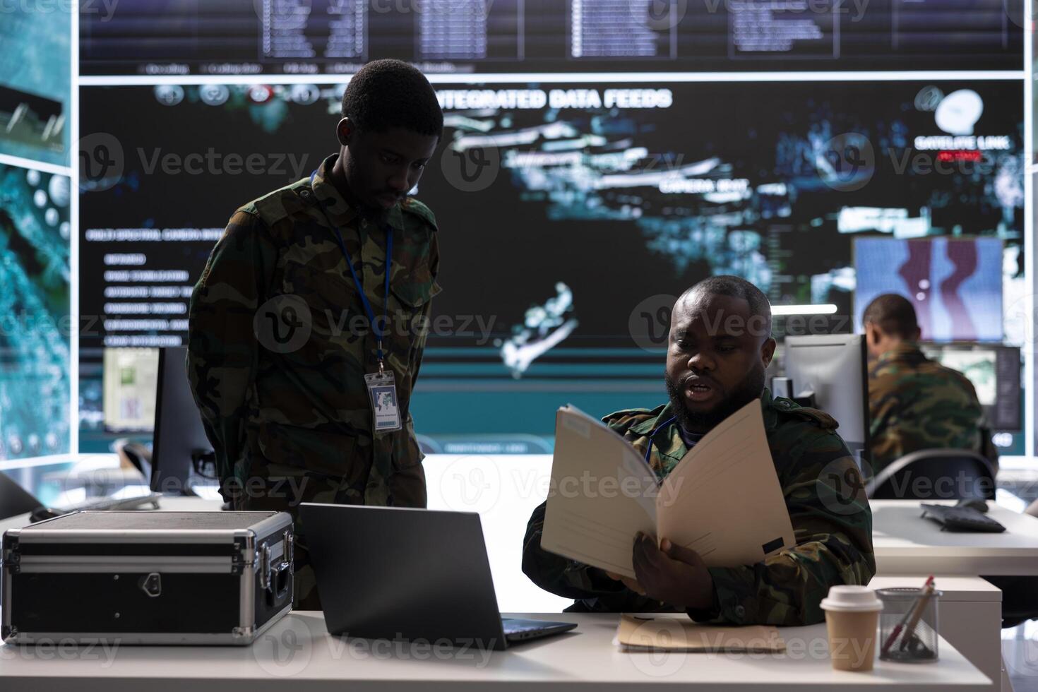 Group of soldiers in an office environment collaborates on intelligence analysis, data interpretation and strategic planning to maintain national security. Military drone control crew. photo