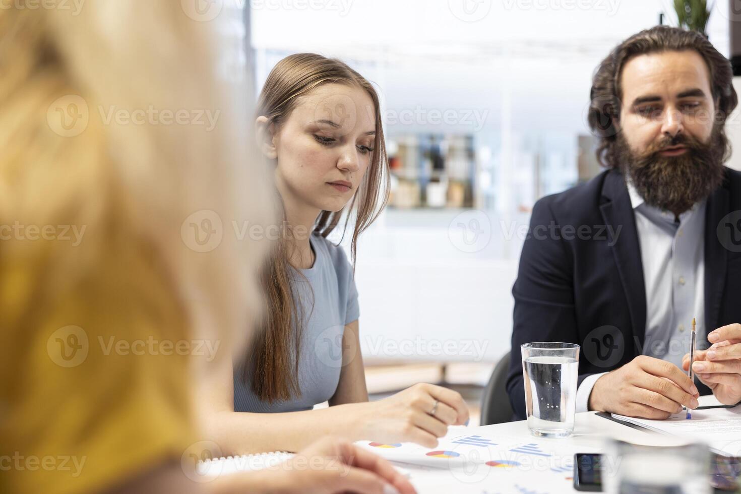Financial advisor assessing clients economic goals to provide personalized planning guide during office meeting. Agent optimizing investment returns for mother and daughter requesting help photo