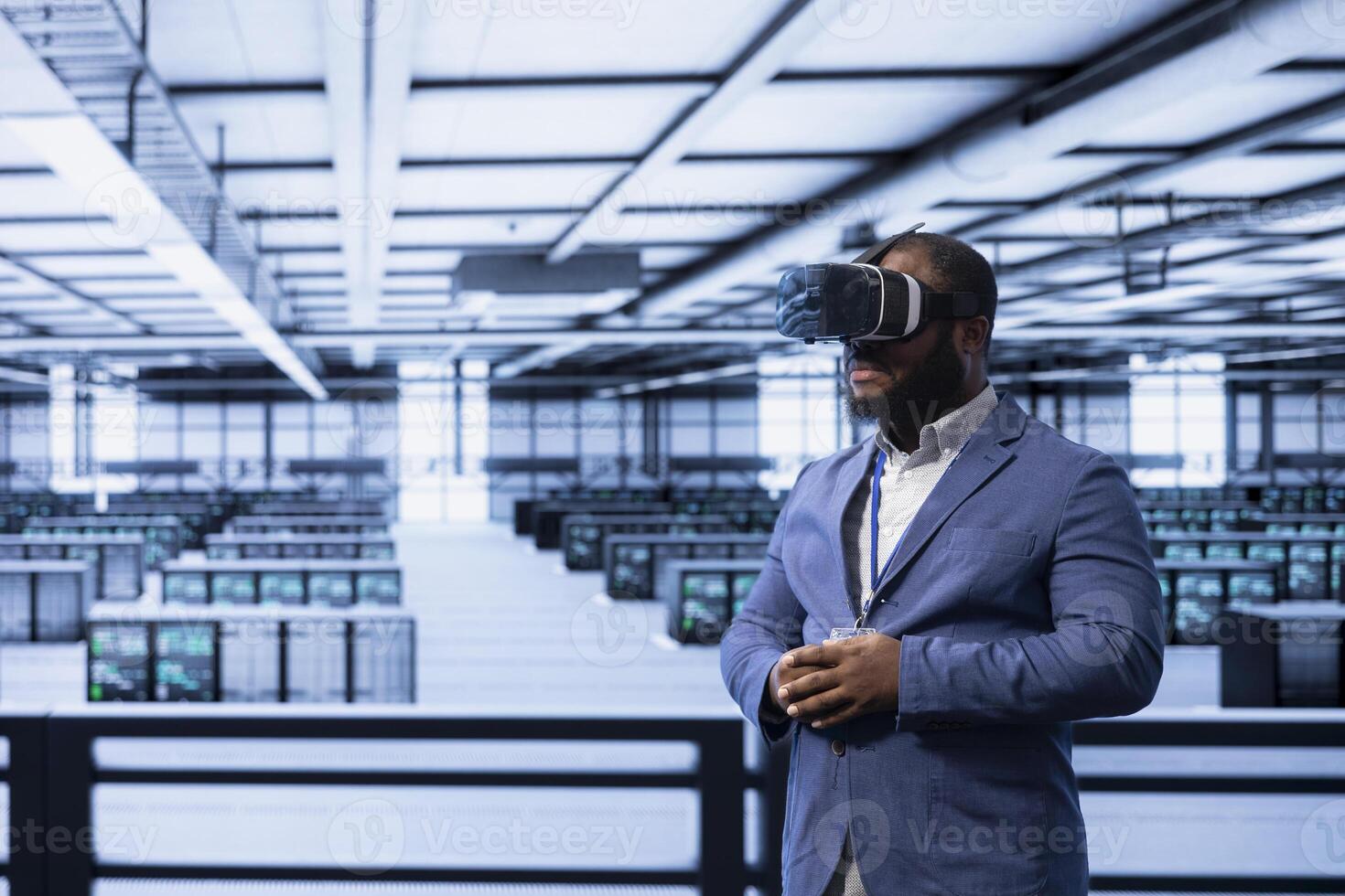 Programmer in server hub using VR headset to implement and maintain security measures, protecting systems from unauthorized access. Data center employee does hardware maintenance using virtual reality photo