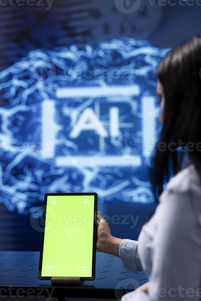 Admin running AI cognitive computing tech on mockup tablet to simulate computerized model. Close up of green screen device used by IT specialist to do data mining with artificial intelligence photo