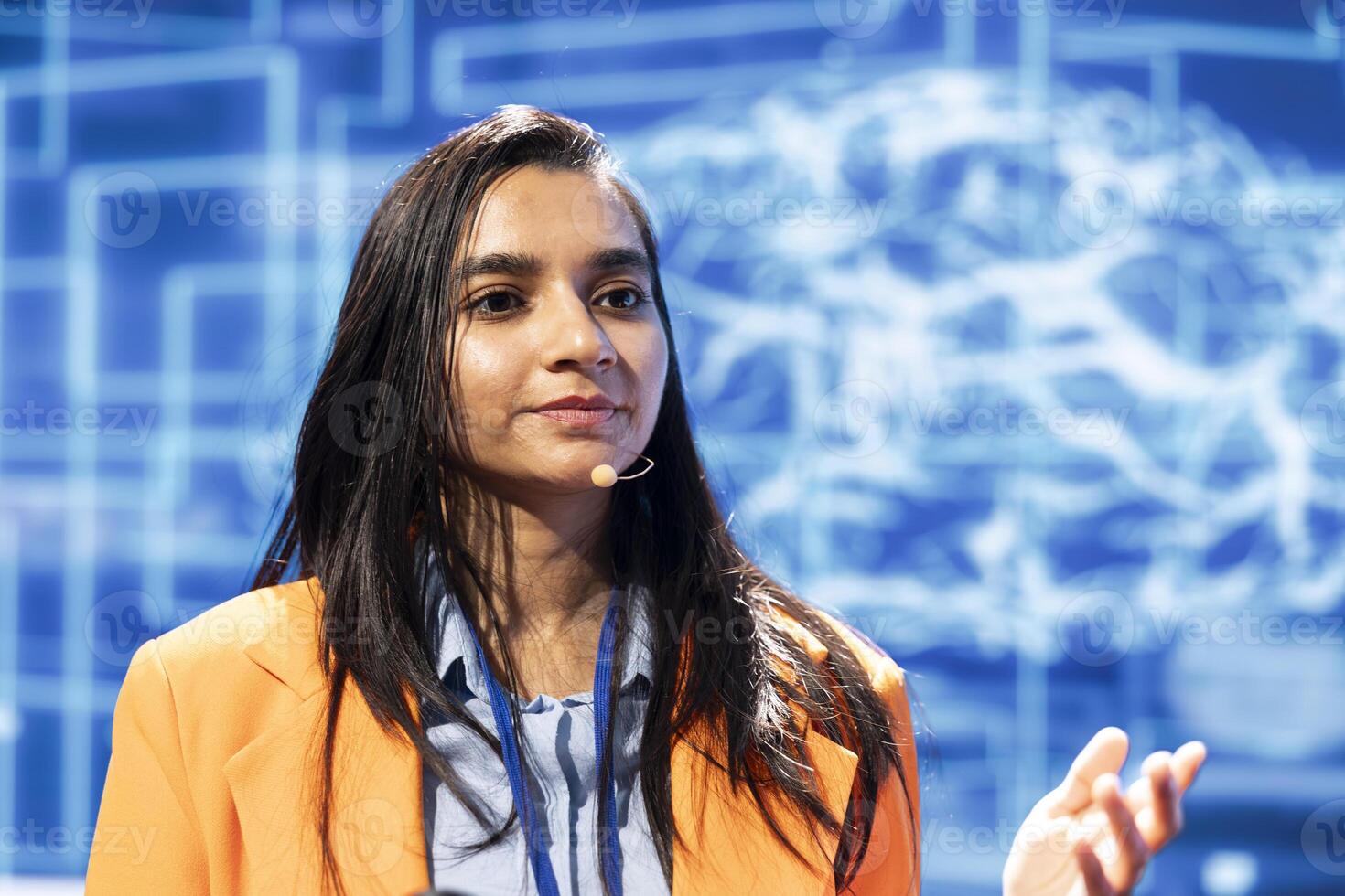 Speaker using headset mic to talk at event bringing together industry specialists to share insights on latest advancements in AI. Close up shot of CEO speaking at expo in front of entrepreneurs photo
