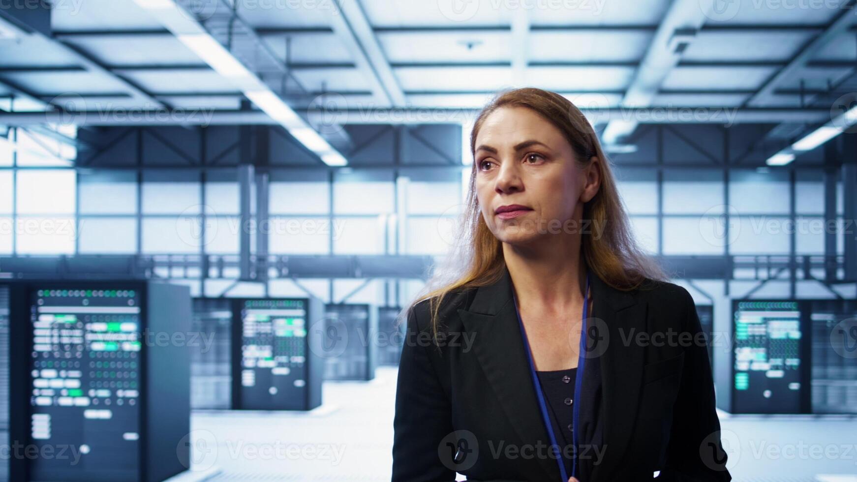 Manager inspecting server room equipment, walking between supercomputers. Supervisor doing evaluation of data center location, checking equipment, monitoring performance, camera B photo