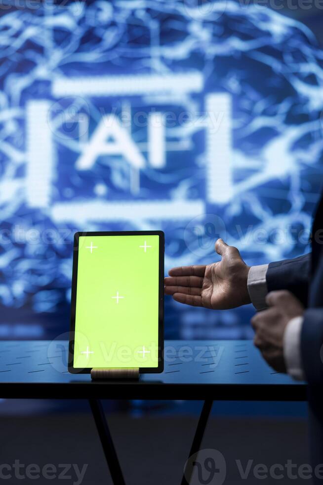 Programmer analyzing complex AI brain models on isolated screen tablet. IT worker using machine learning software on mockup device to develop artificial intelligence technology photo
