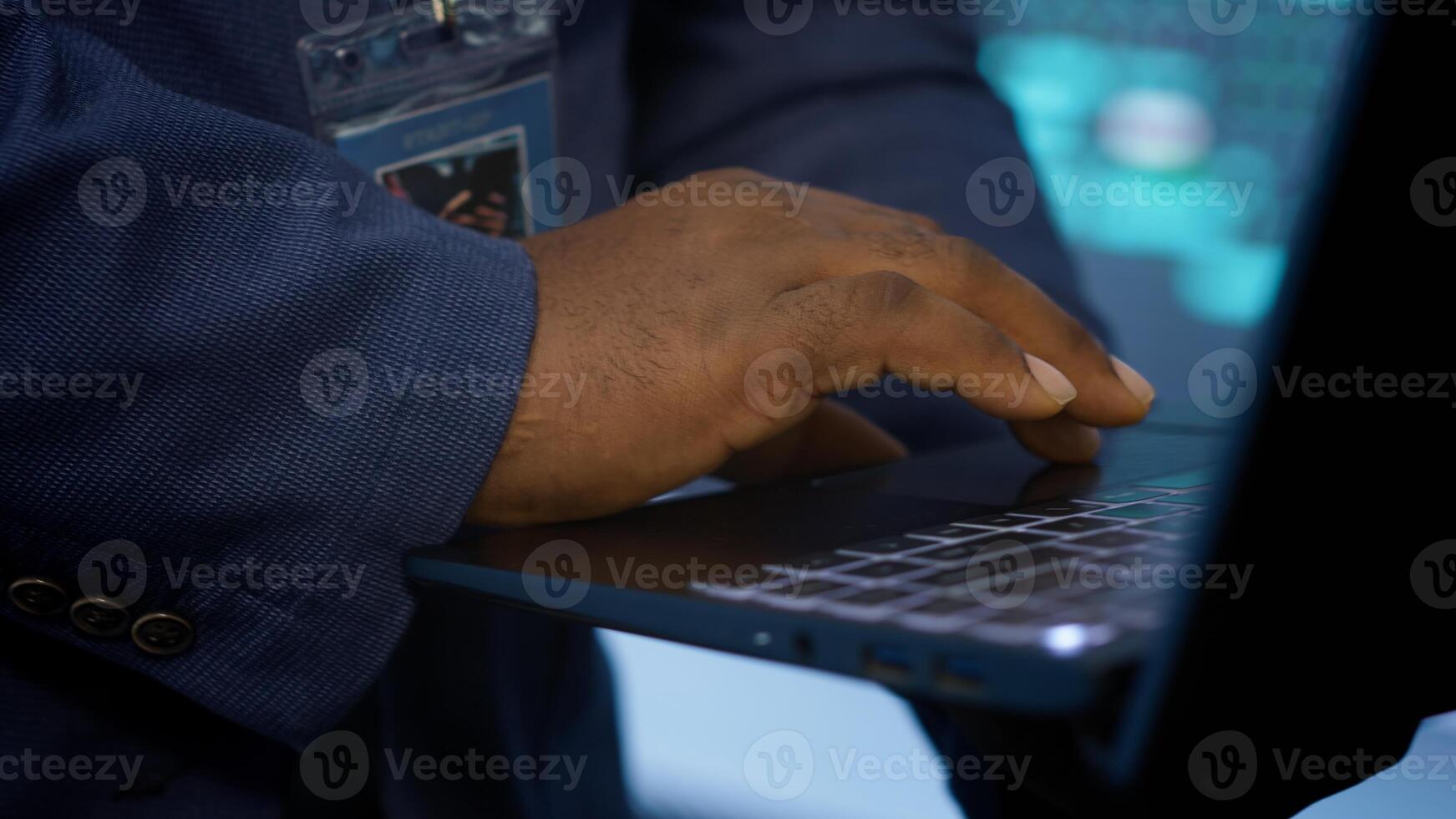 IT technician working on notebook in data center, overseeing server operations. Extreme close up shot of man ensuring optimal performance and data integrity in server hub, camera A photo