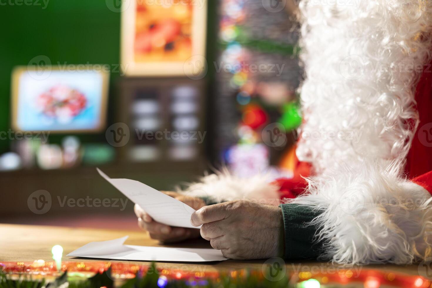 Saint Nicholas reading through Christmas letters from children around the world, planning the perfect presents. Man with iconic red suit and white beard represents the festive season. photo