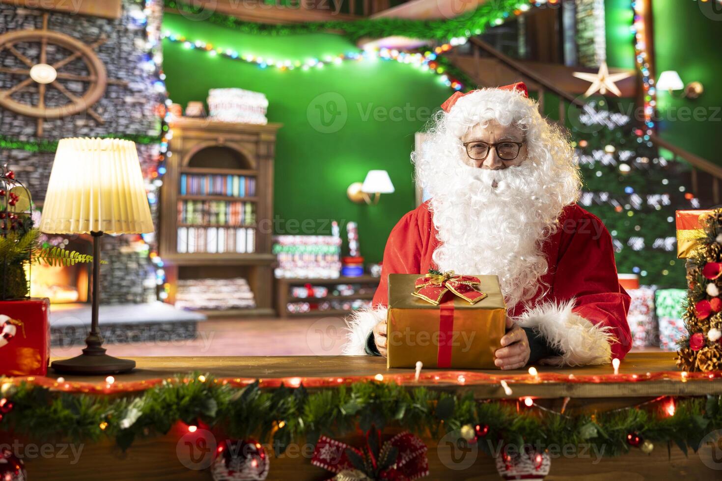 Father Christmas decorates gifts with wrapping paper and ribbons in his North Pole workshop, getting ready to deliver the presents on x mas eve. Festive season with decorations and holiday magic. photo