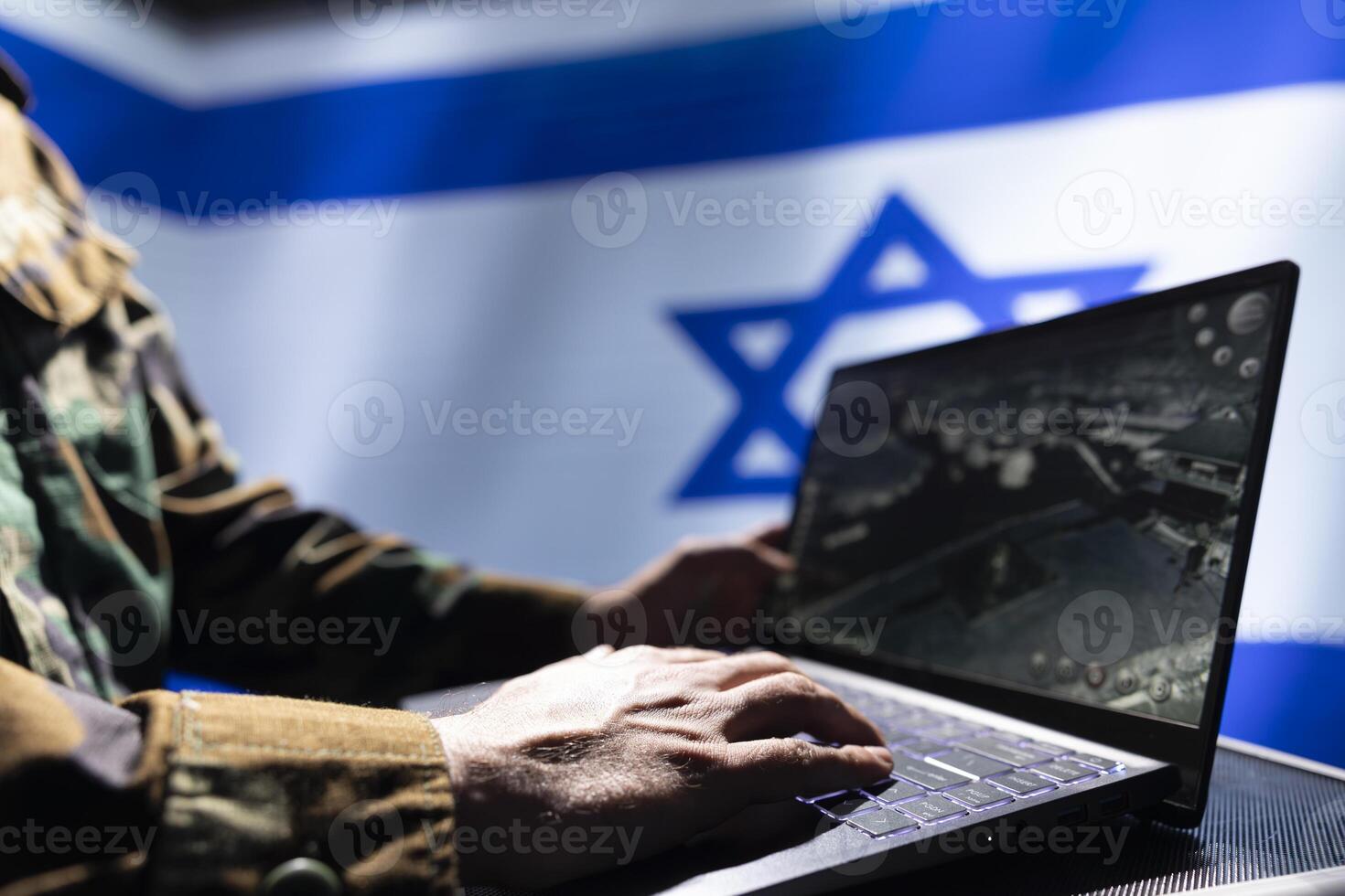 IDF army soldier using laptop, operating anti ballistic system designed to counter missiles threatening country. Close up of Israeli intelligence corps officer defending nation against rockets photo