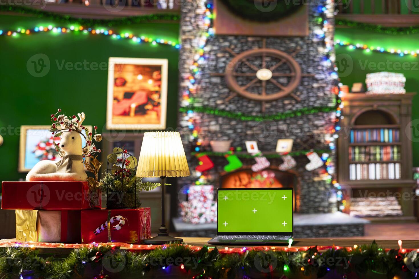 Empty cabin decorated with garlands and baubles next to isolated mockup, awaits Santa Claus at the North Pole. The festive cozy workshop having wrapped gifts ready for a magical Christmas night. photo