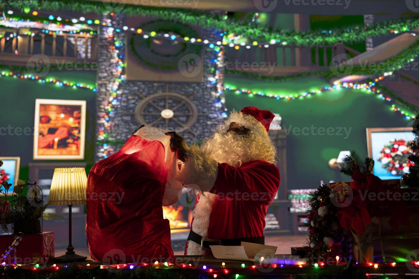Amazed african american Santa Claus opening his bag full of gifts, Christmas spirit lights shining bright and spreading the holiday cheer. Saint Nicholas enjoying x mas in his log cabin. photo