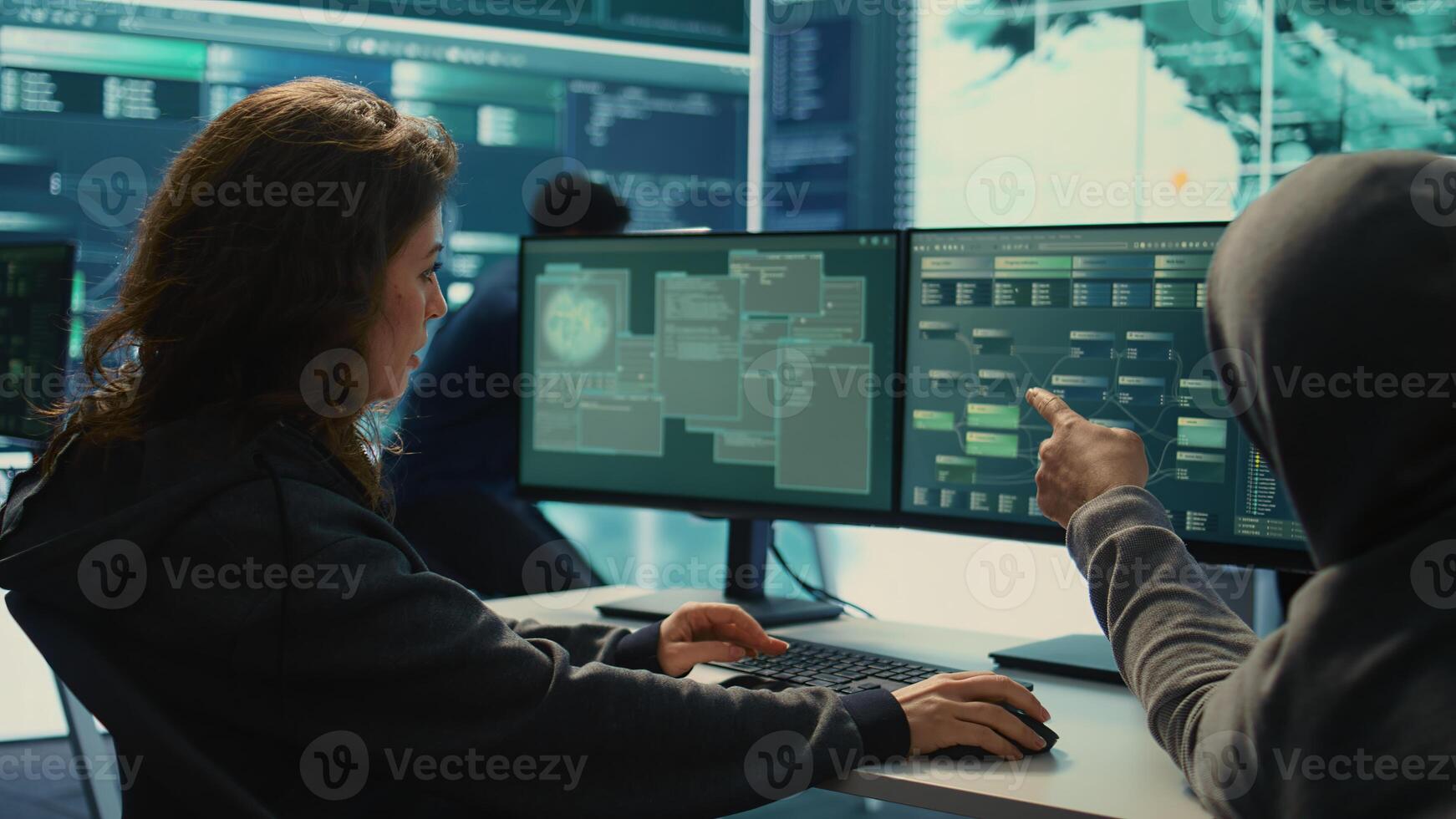 Governmental hackers team working on digital security and cyber defense measures, using pc and big screen. Experts focusing on cyber operations, network security and server protection. Camera B. photo