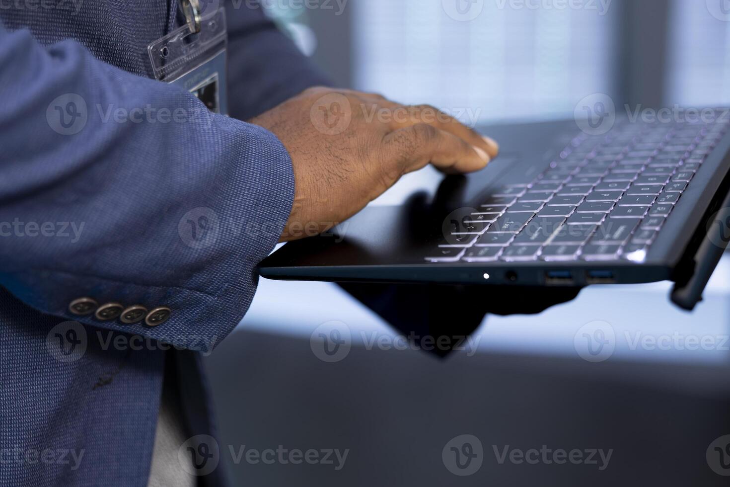 Admin in data center uses tools on notebook designed to handle challenges of managing cloud and distributed infrastructure. Close up of worker planning and executing server hub migrations and upgrades photo