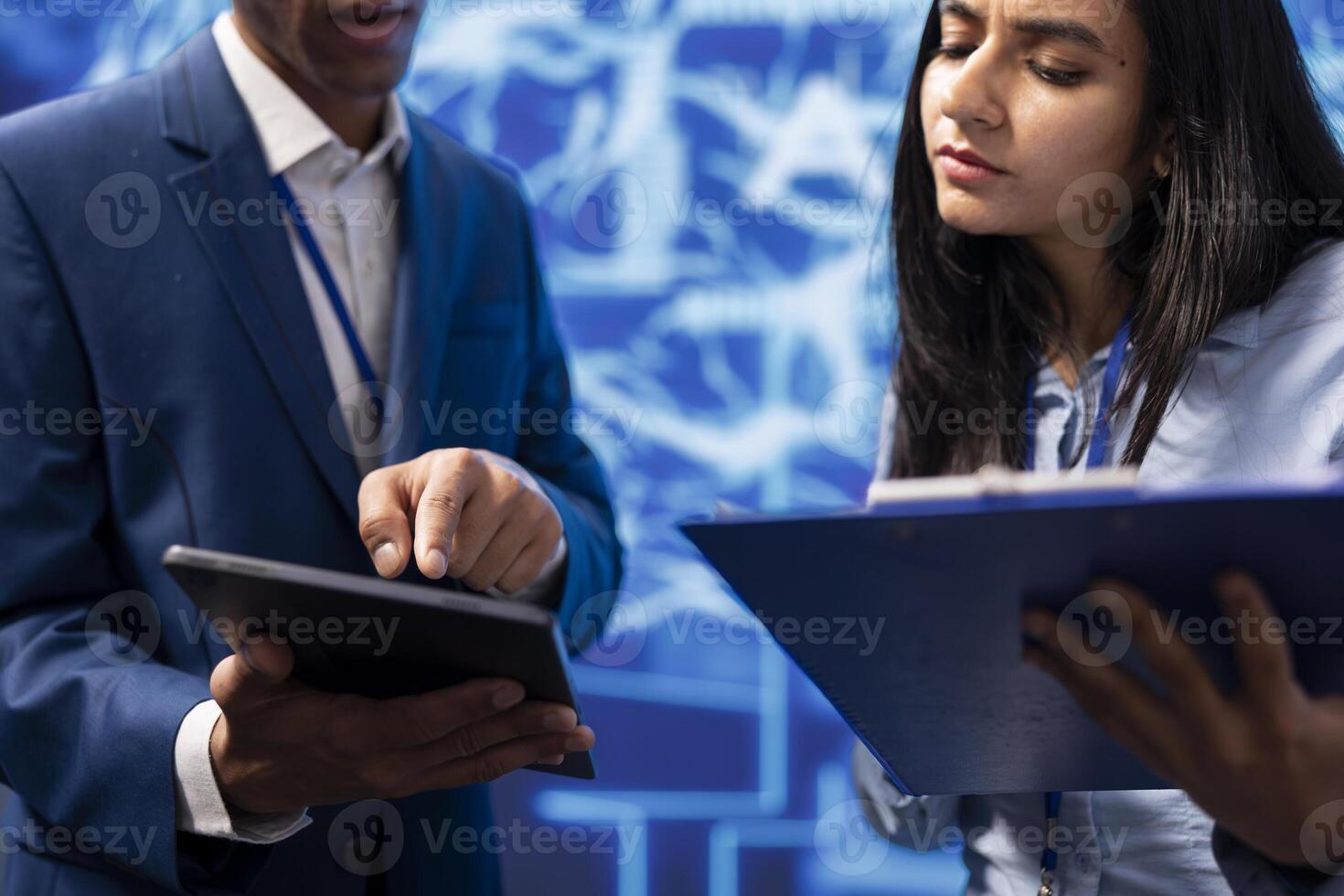 Developer and colleague analyzing complex AI brain models on tablet. IT specialist and coworker using machine learning software on device to develop artificial intelligence technology photo