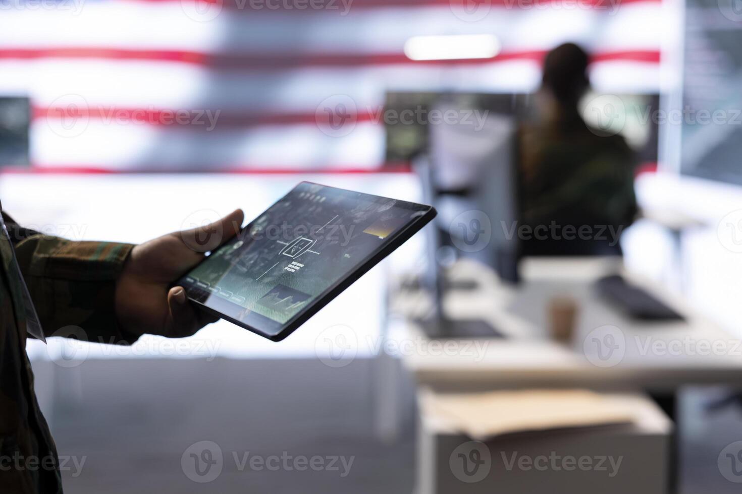 Team of military experts operates high tech computers and tablet to analyze surveillance data and manage national security operations. Working with CCTV radar satellite imagery. Close up. photo