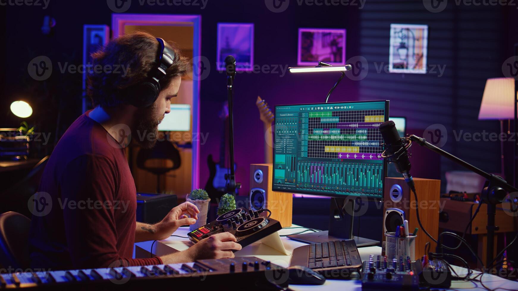 Audio engineer creating sound effects for a new soundtrack, recording tunes on electronic piano and adding creativity to audio project. Songwriter producer editing and mixing recordings. Camera B. photo
