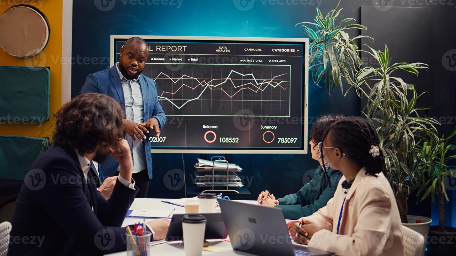 Digital marketing team attending an innovation and brainstorming meeting in boardroom, analyzing sales reports to understand market trends. Working on enterprise growth solutions. Camera B. photo
