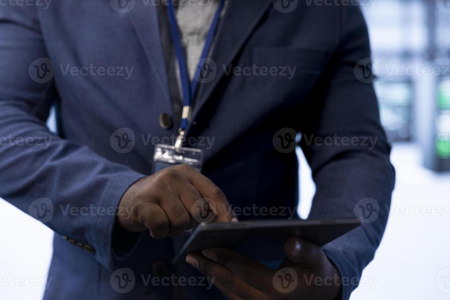 Data center admin ensuring safety and security of database using device. Close up of server hub expert preventing unauthorized access and suspicious activities posing risks for business photo