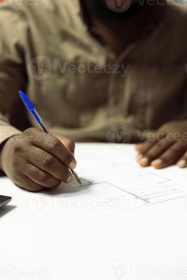 Entrepreneur evaluating and drafting blueprints to design the new office space layout, working on architectural sketches, Looking to invest in real estate for business development. Close up. photo