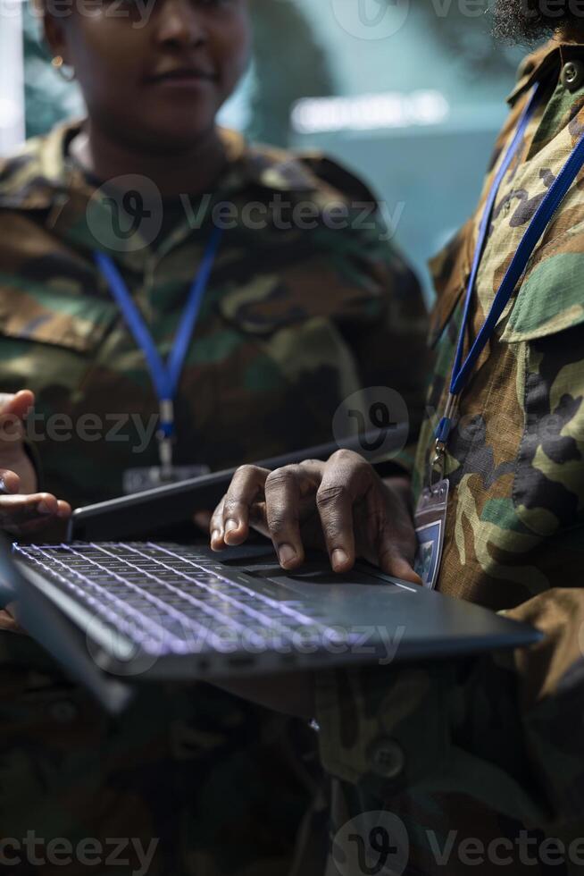Army staff establishing new operating bases on a satellite world map visualization, ensure the national safety from the monitoring room at the base. Troopers operate CCTV radar footage. Close up. photo