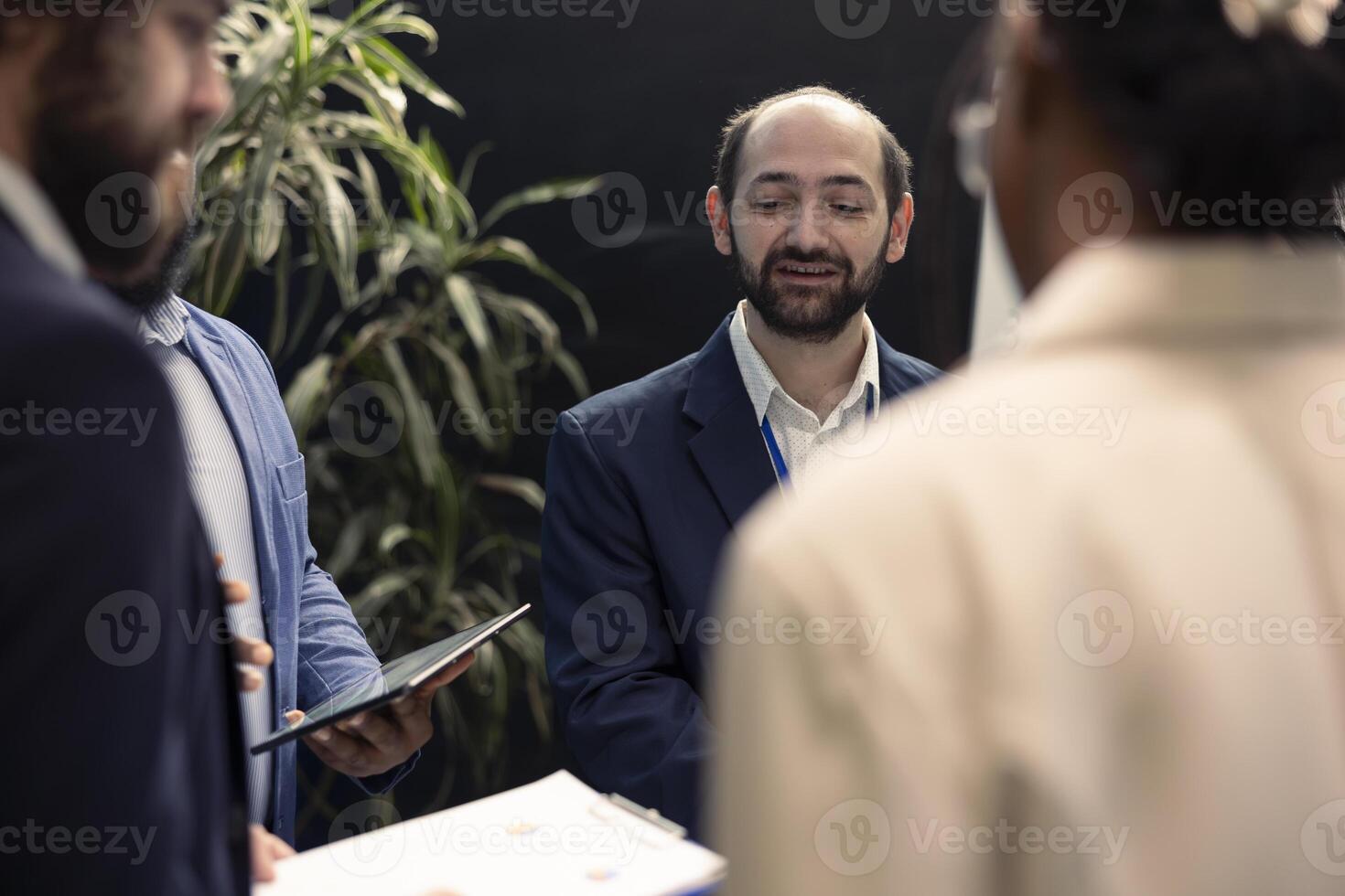 Corporate associates looking into project details and timetables in conference room, establishing budget and operations plan to accomplish objectives in a competitive business environment. photo