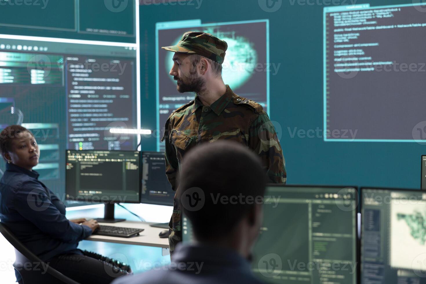 Military hackers working on cyber security in a high tech government center. Focusing on network protection, encryption and preventing cyber attacks to safeguard state secrets. photo