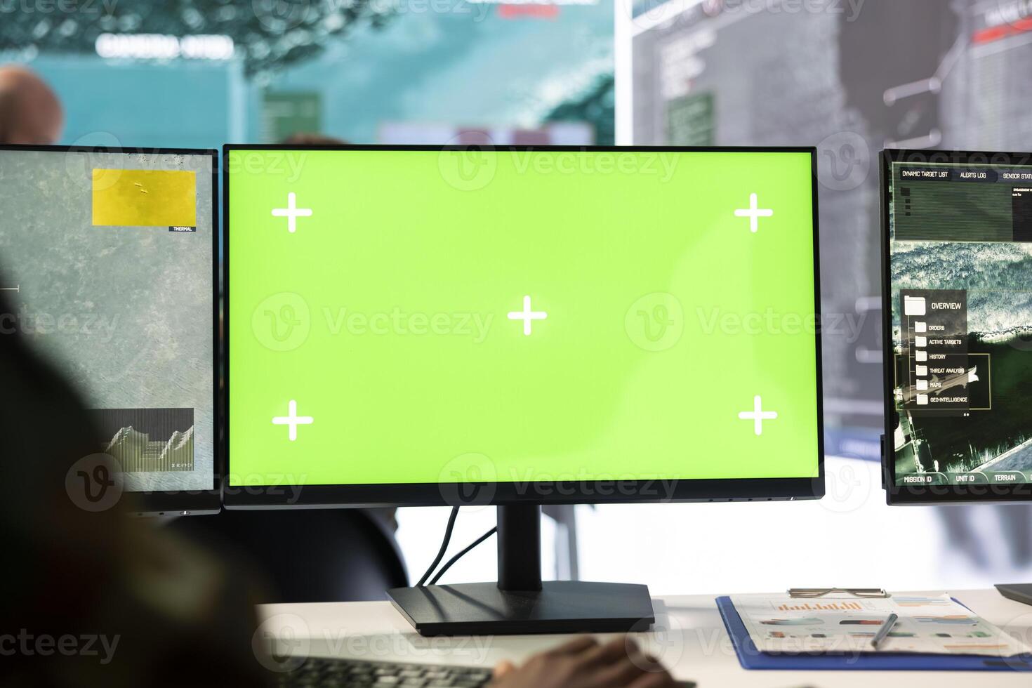Recruit operates on reconnaissance CCTV footage with green screen, using military radar imagery in military control room. Monitoring real time data in a defense base of operations, security mission. photo