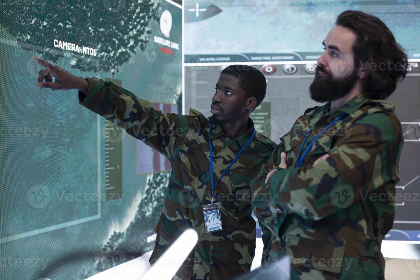 Team of recruits examining new surveillance footage on a big screen, gathering intelligence from satellite radar system in military monitoring room. GPS tracking on a world map, navy division. photo