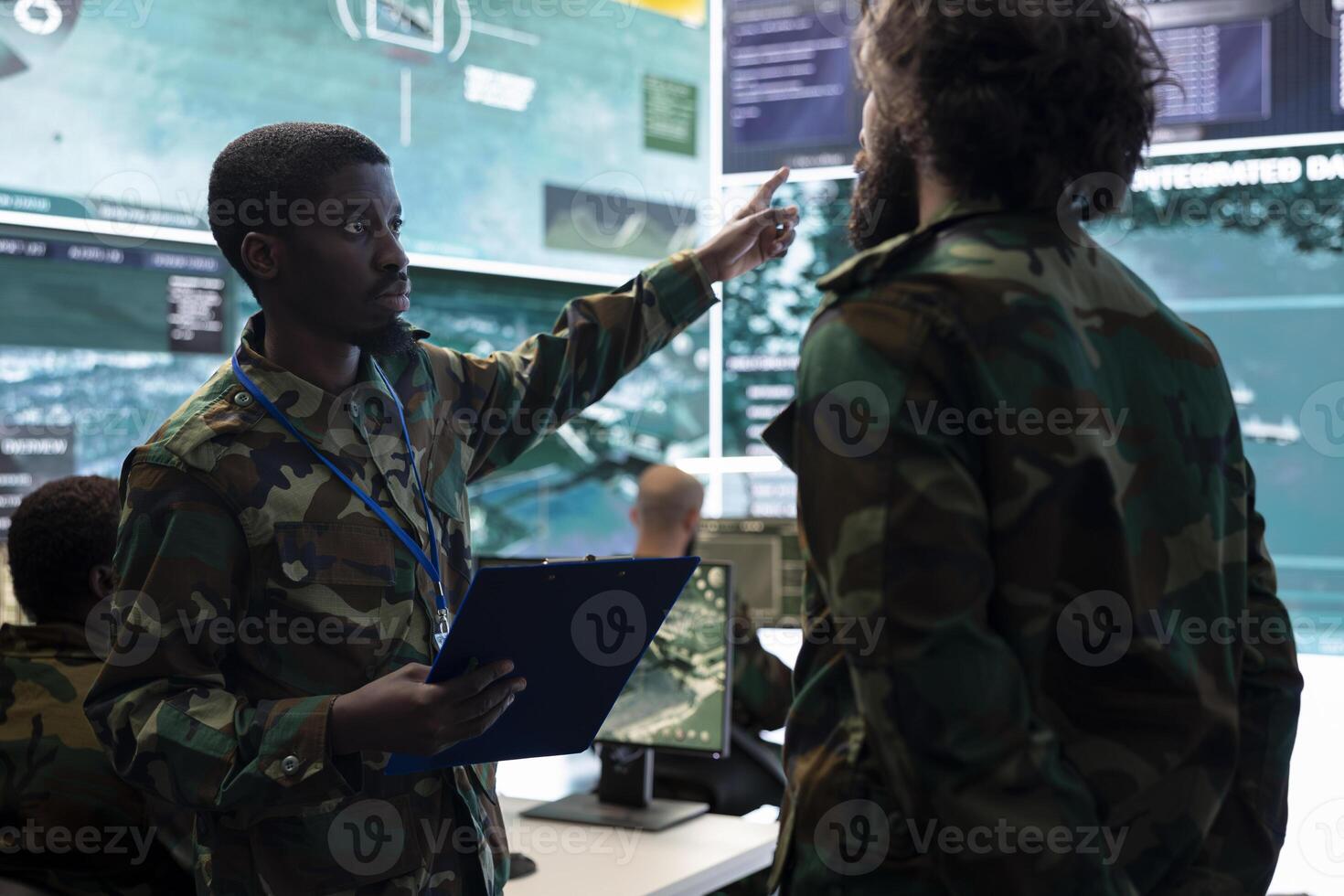 Troopers providing a new national safety program in military general headquarters, ensuring peace from a federal control center. Soldiers examine CCTV surveillance satellite system, army division. photo