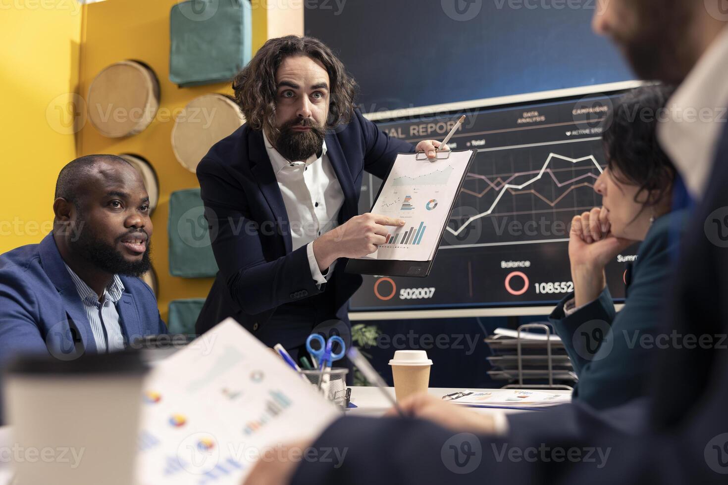 Angry stressed manager working under pressure with his staff, studying infographics and making changes for enterprise development. Tensed forecast associates meeting in boardroom space. photo