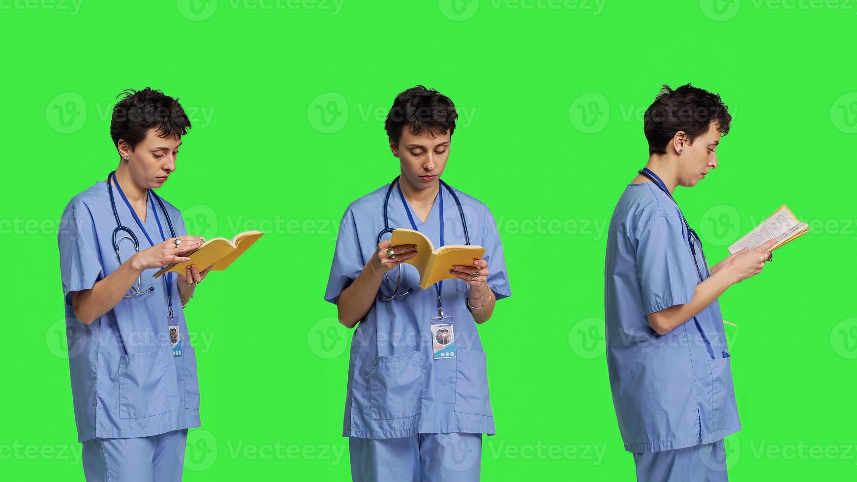 Medical assistant reading a literature book against greenscreen backdrop, enjoying healthcare industry lecture to acquire new expertise. Nurse paying attention to medicine manual at work. Camera B. photo