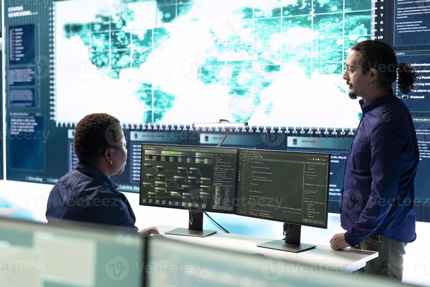 Group of governmental hackers using hacking tools to secure a network, focusing on cyber defense and data protection measures. Experts team examining important information on big screen. photo