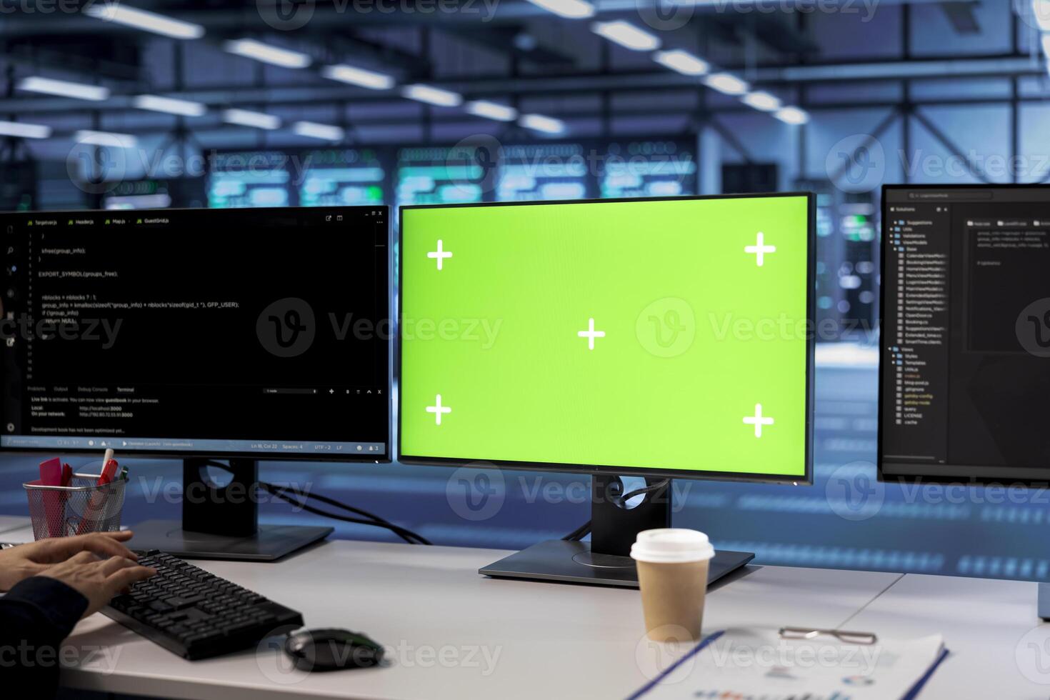 Green screen computers in data center facility managing rackmounts energy consumption. Mockup PC monitors used for automation and monitoring processes in server room, close up photo