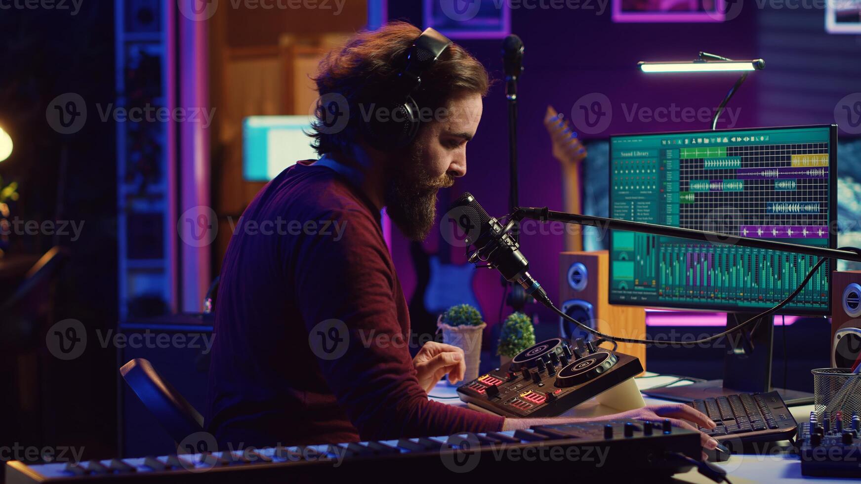 Sound engineer recording backing vocals and singing on microphone, using daw software and mixing console in home studio. Artist listening to mixed tracks and create a good acoustic audio. Camera A. photo