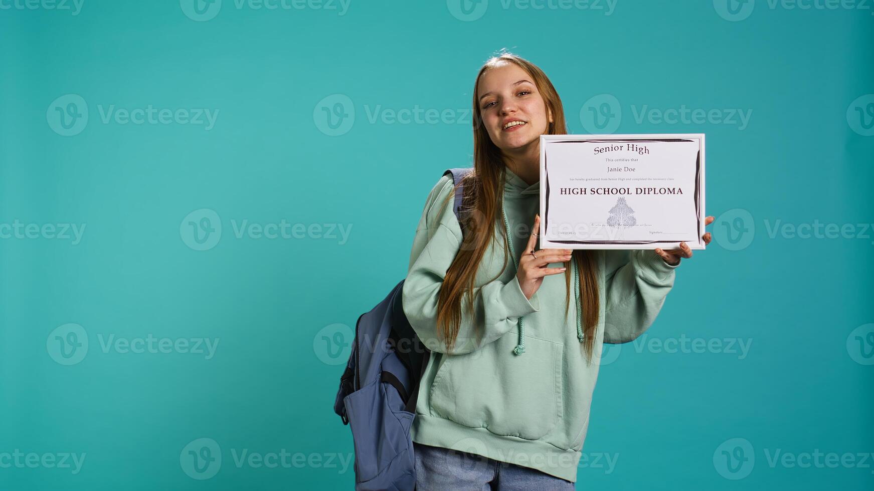 Portrait of smiling student holding high school diploma, celebrating passing classes with high marks, attending graduation ceremony. Happy young girl delighted about receiving certification, camera B photo