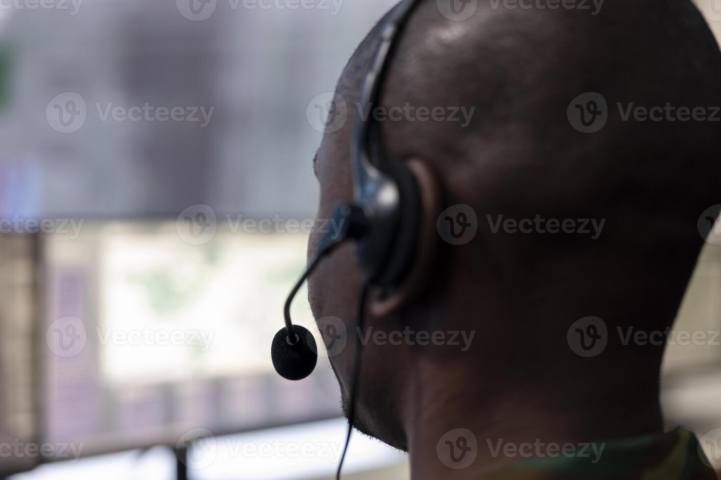 Special operations engineer transmitting crucial information to the army headquarters, IT operator gathers intelligence from CCTV surveillance system. Trooper examines field data. Close up. photo