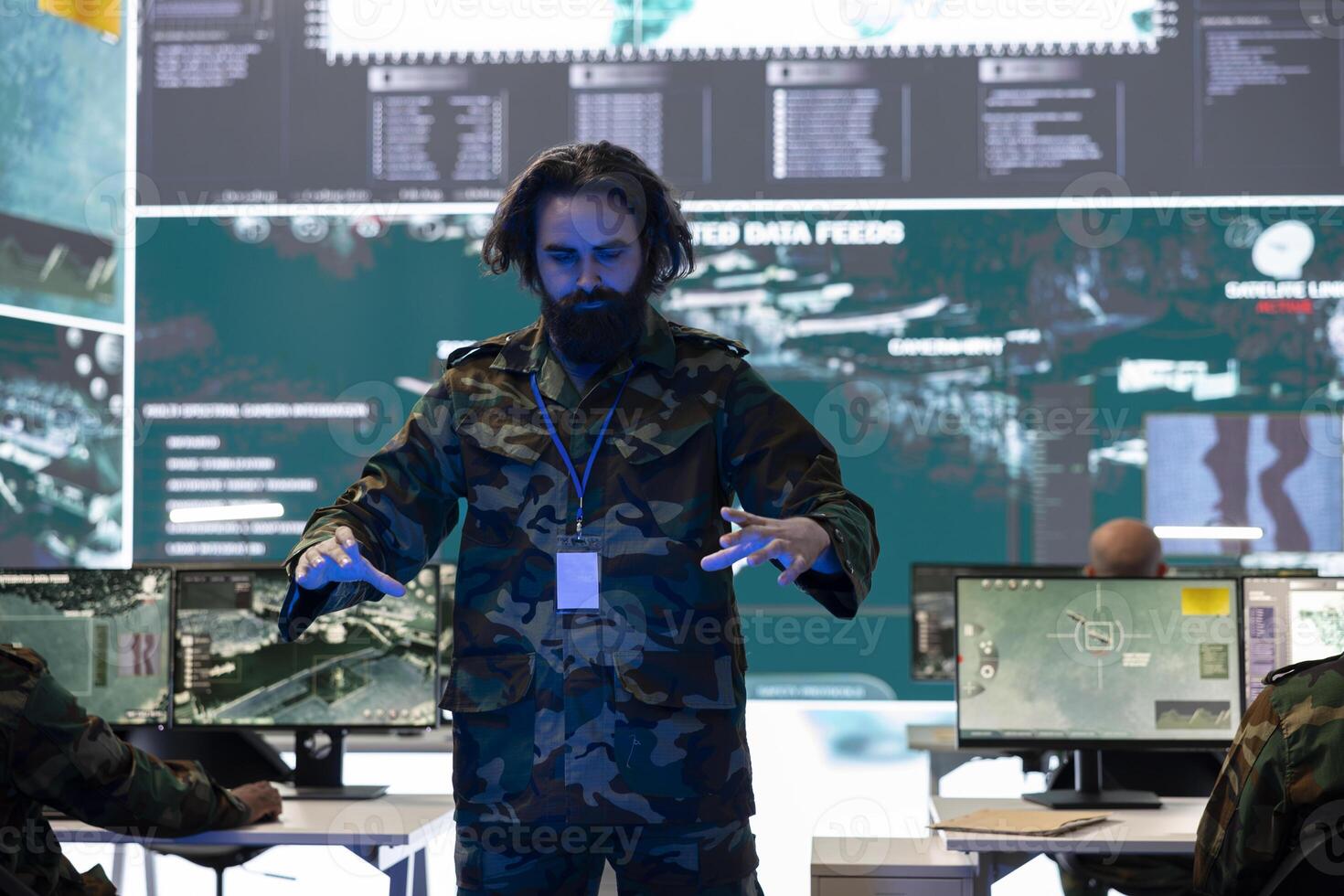 Special operations soldier examines battlefield data on a hologram, working with high tech holographic projection in army command post. Trooper checking defense operation details. photo