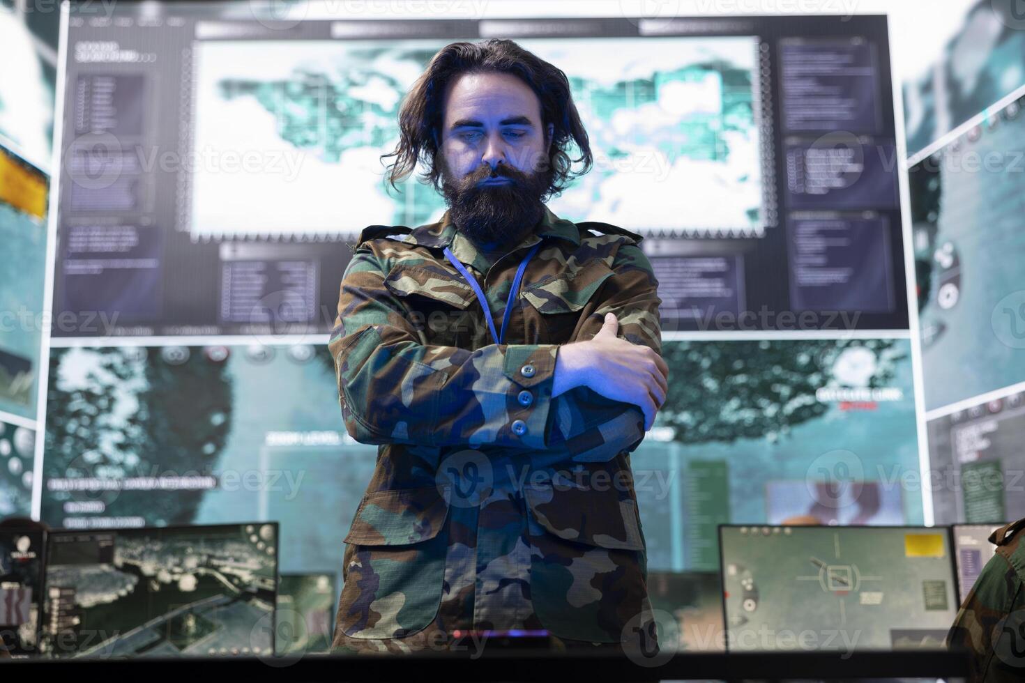 Army officer examining information on a hologram projection in control room, creating a battlefield map for the infantry unit troopers. Soldier monitoring radar surveillance system. photo