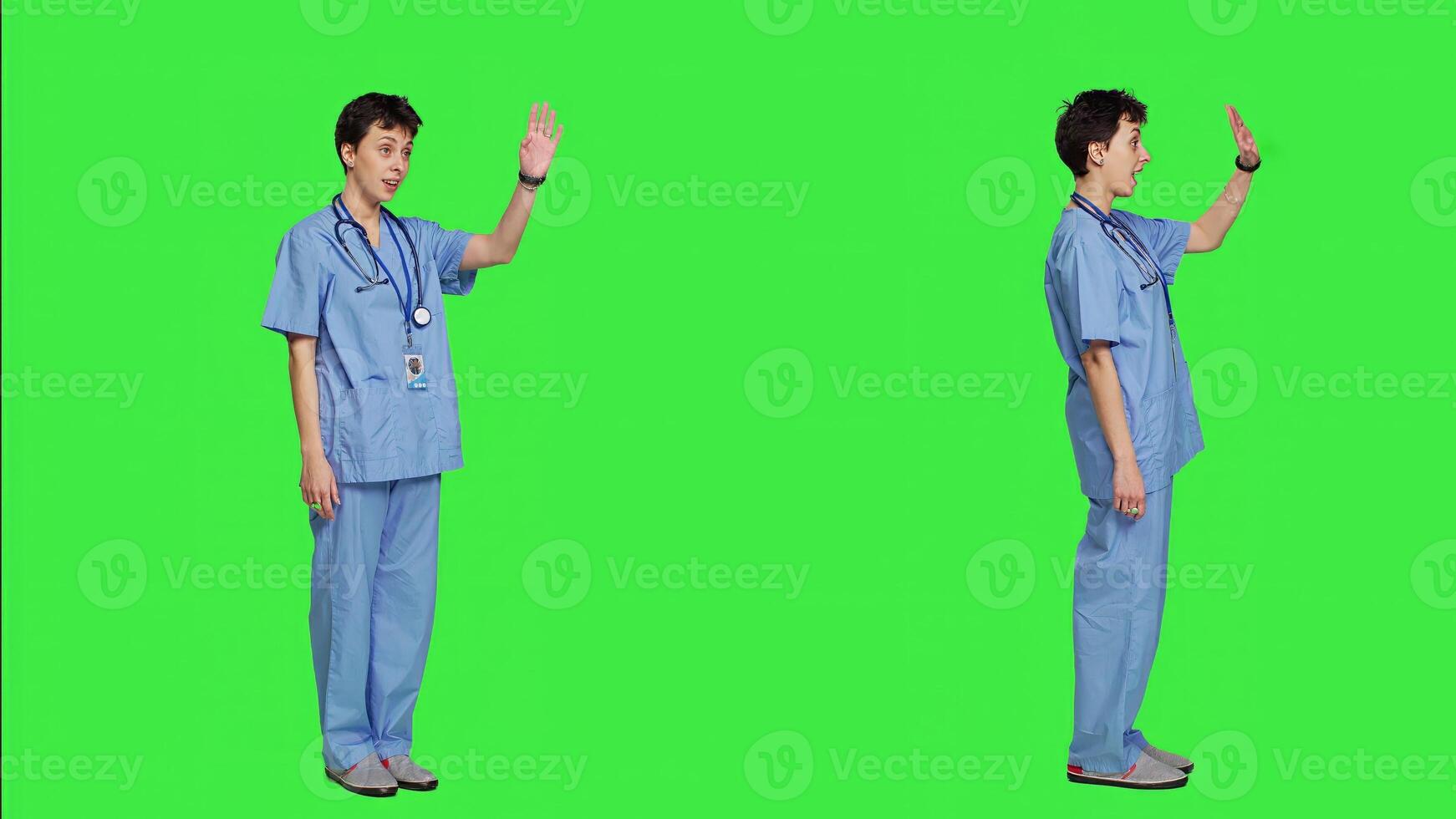 Medical assistant calling people over to come closer for examination, inviting patients at cabinet for checkup. Nurse with scrubs stands against greenscreen, come at me concept. Camera A. photo