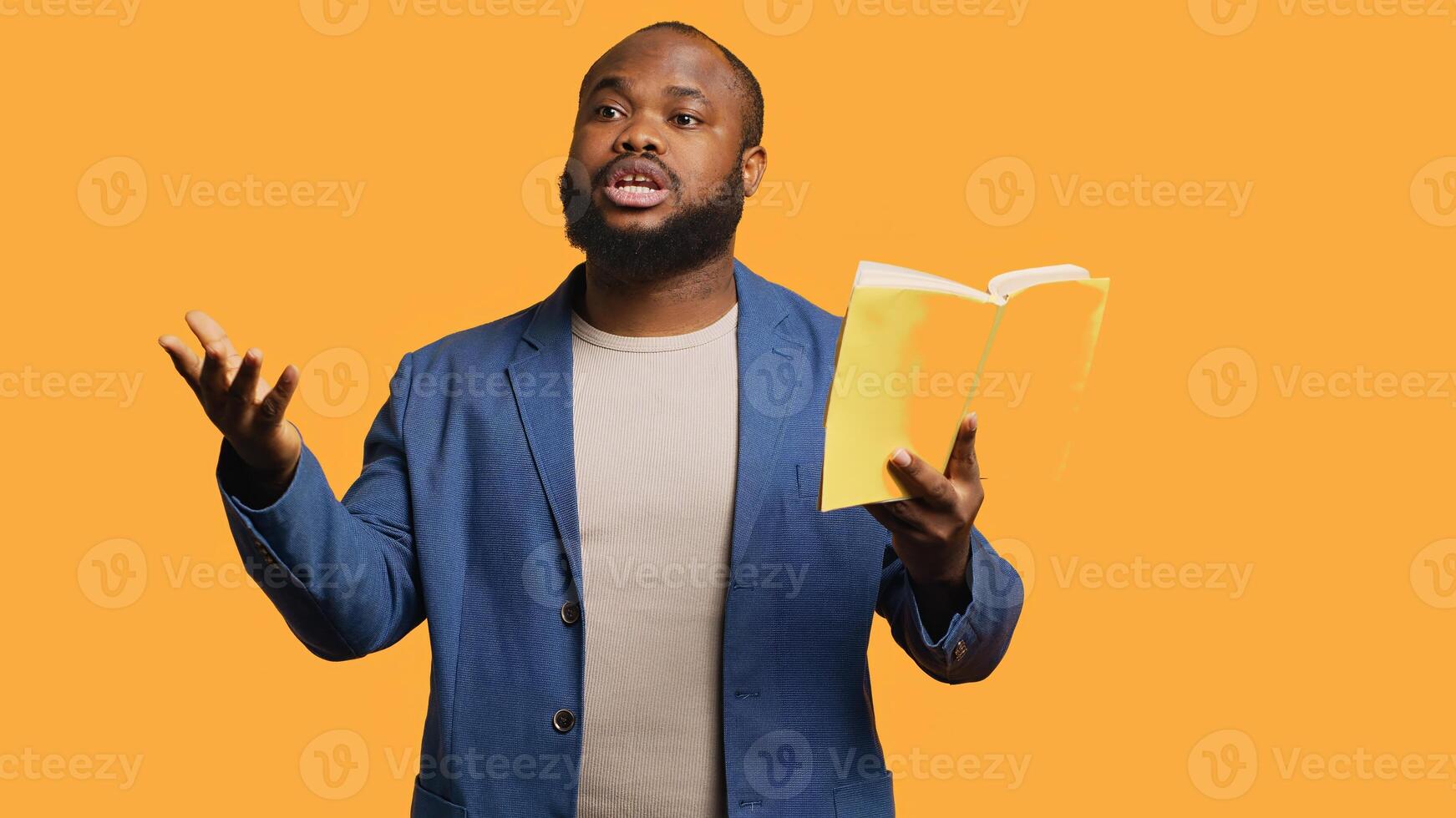 Man reading book aloud, narrating story for audience, doing monologue for theatre play. Person rehearsing using literature novel source material, reciting from pages, studio background, camera A photo