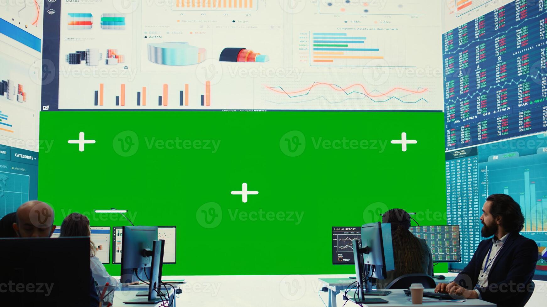 Business partners working in telecommunications control room with a big isolated mockup screen, reviewing key performance indicators within the enterprise activity. Conducting evaluations. Camera A. photo